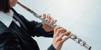 A person playing a reverse flute
