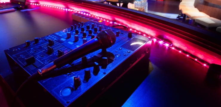 a dynamic microphone on top of a dj mixer