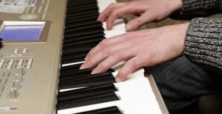 a person playing on their digital piano