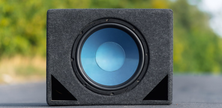 a subwoofer on the ground of a street
