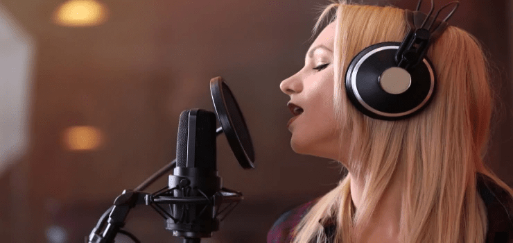 a-woman-recording-in-a-studio-with-a-condenser-microphone