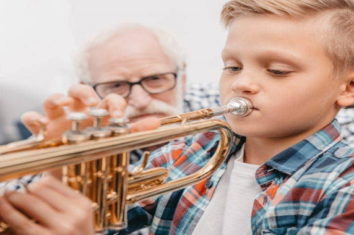 boy learning how to play the trumpet