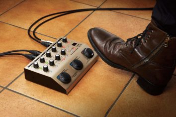 Somebody using their foot on a vocal processor